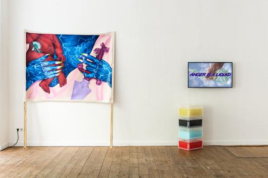 Photo of an exhibition with one painting on the left side which depicts two hands. One hand is called care and holds a baby with red skin, the other hand is called rage and holds a weapon .